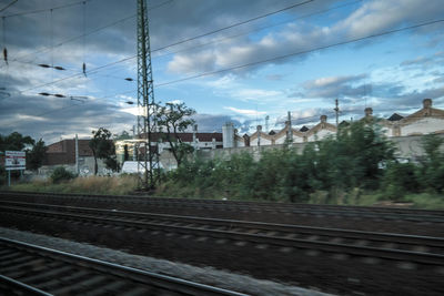 Railroad track against cloudy sky