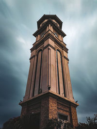 Low angle view of clock tower with silky clouds background