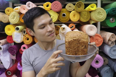 Portrait of young man holding food