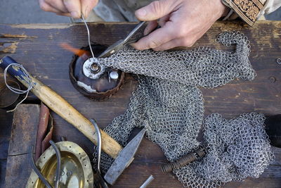 High angle view of man repairing armor