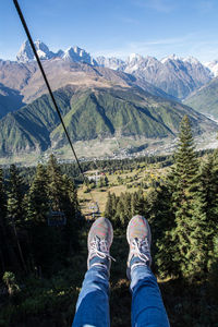 Low section of man standing on mountain