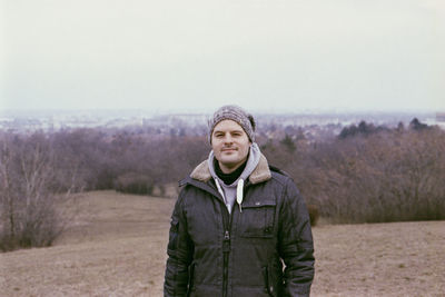 Portrait of mature man wearing warm clothing while standing on land