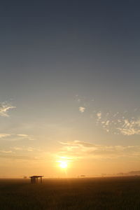 Scenic view of field against sky during sunset