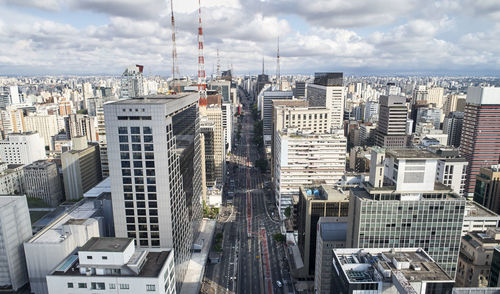 Aerial view of buildings in city against sky
