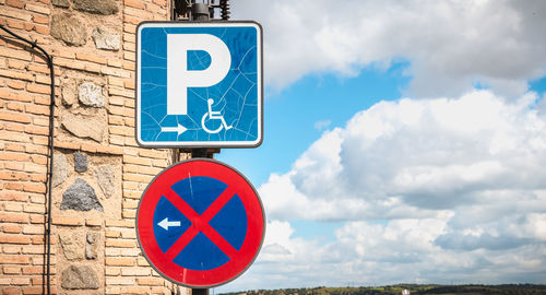 Low angle view of road sign against sky