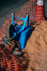 Upside down wheelbarrow on sand