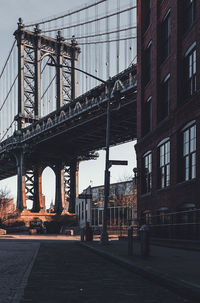 View of bridge in city against sky