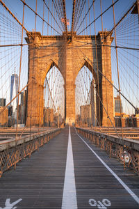 Brooklyn bridge against blue sky