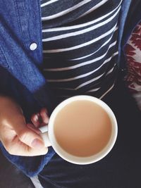 Close-up of woman holding coffee cup