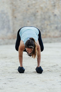 Young woman doing yoga positions in urban environment.