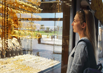 Side view of woman looking at store