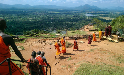 Rear view of people looking at mountains