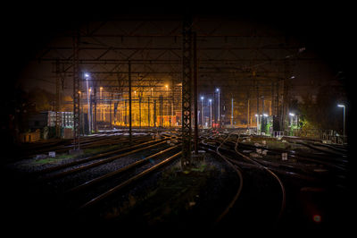 Railroad tracks on field at night