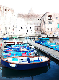 Boats moored at harbor in city