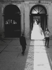 Full length of woman walking in tunnel