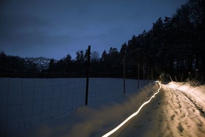 Scenic view of landscape against sky at night during winter