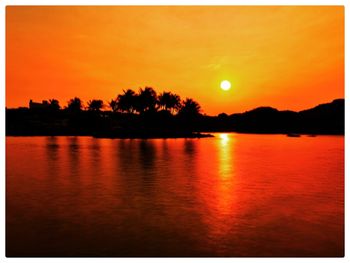 Scenic view of lake against romantic sky at sunset