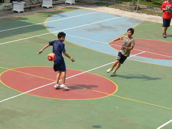 Boy playing with soccer ball in background