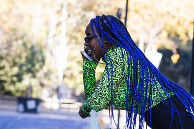 Side view of woman looking away outdoors