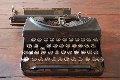 Close-up of broken typewriter on table