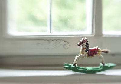 Toy on window sill at home