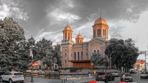 Panoramic view of buildings and trees against sky in city