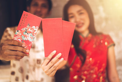 Close-up of woman holding red umbrella