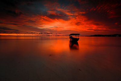 Scenic view of sea against orange sky