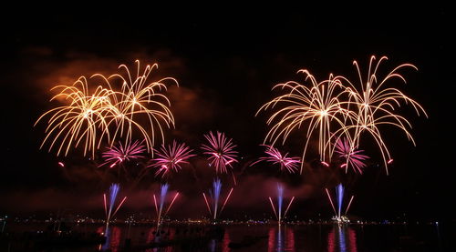 Low angle view of firework display at night