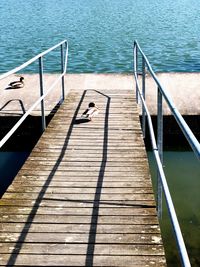 High angle view of person on pier at swimming pool