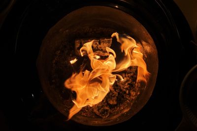 High angle view of burning candles on wood