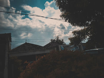 Houses and trees against sky at dusk