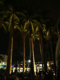 Crowd at music concert against sky at night