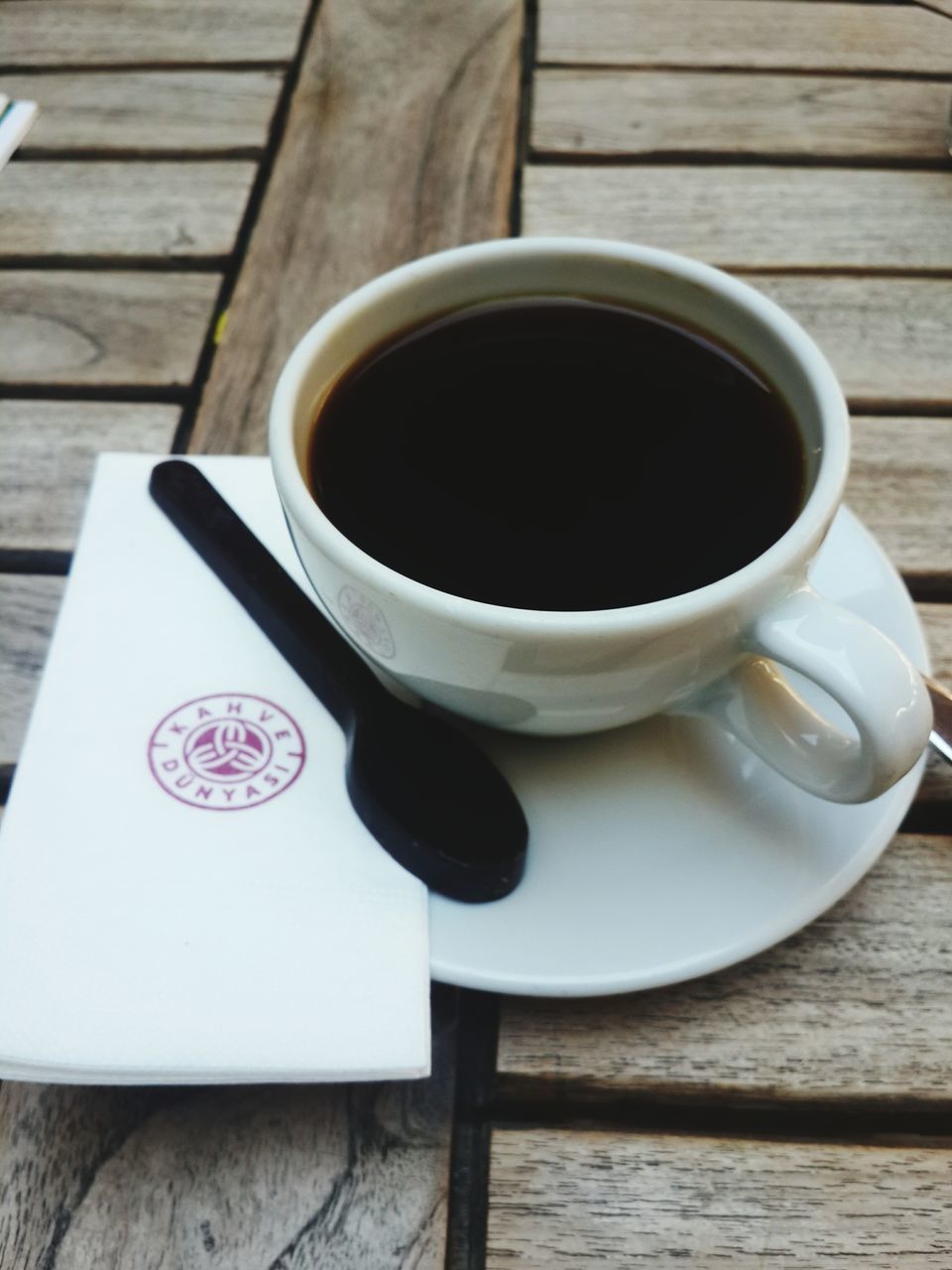 coffee cup, drink, refreshment, coffee - drink, indoors, table, saucer, food and drink, coffee, still life, cup, freshness, tea cup, close-up, high angle view, tea, spoon, wood - material, beverage, black coffee