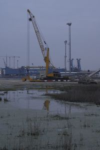 Cranes against sky