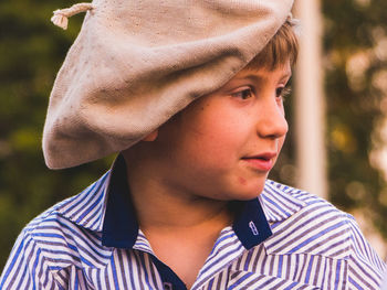 Close-up of thoughtful boy wearing flat cap