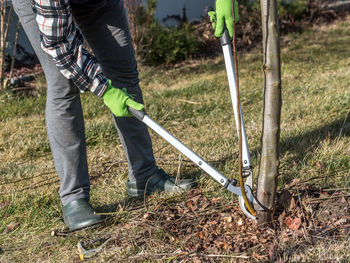 Low section of man working on field