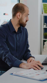 Side view of man working at office