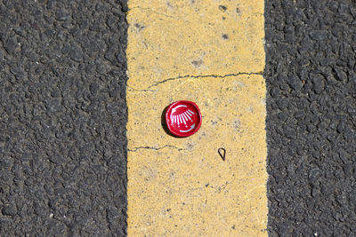 High angle view of bottle cap on road