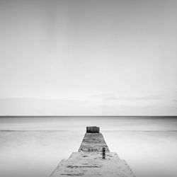 Pier amidst sea against sky