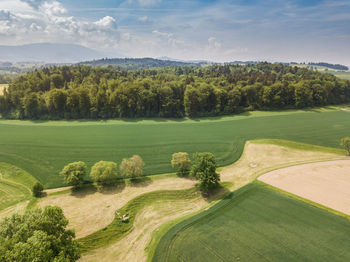 Scenic view of golf course against sky