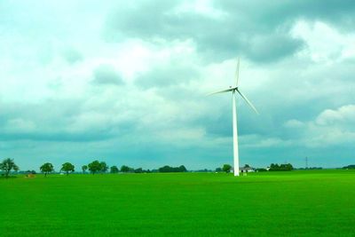 Windmill on field against sky