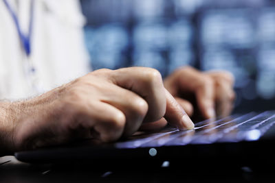 Midsection of man using laptop