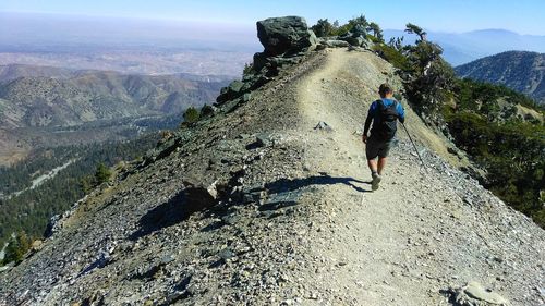 Rear view of man walking on mountain