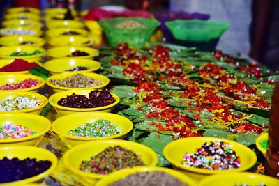 Close-up of multi colored ingredients and beetle leafs for sale in market