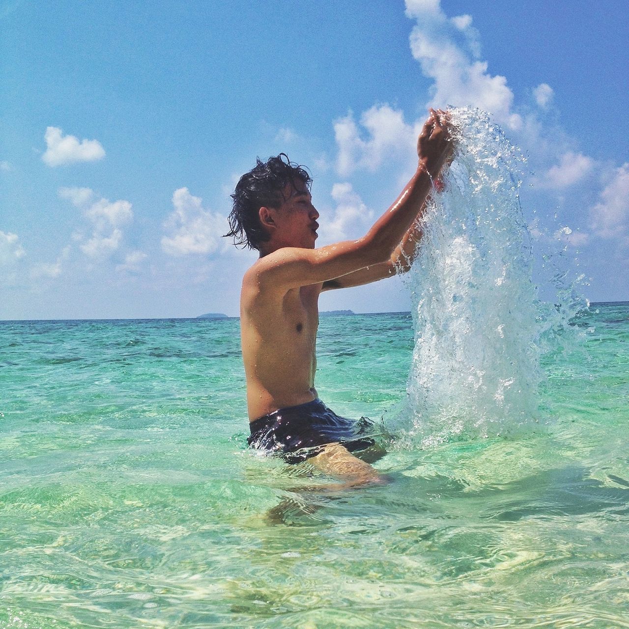 water, sky, sea, leisure activity, lifestyles, blue, waterfront, cloud - sky, splashing, motion, enjoyment, cloud, nature, full length, day, vacations, horizon over water, beauty in nature