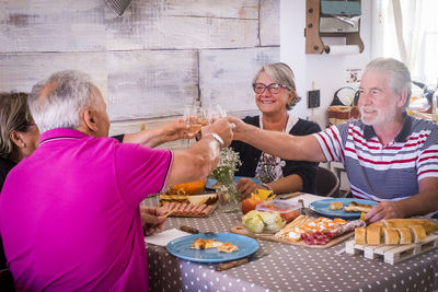 Senior friends sitting at dining table during breakfast