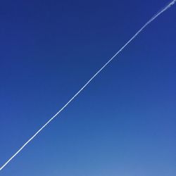 Vapor trail against clear blue sky