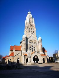 Low angle view of building against blue sky