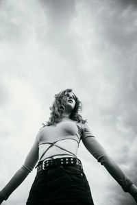 Low angle view of woman standing against sky